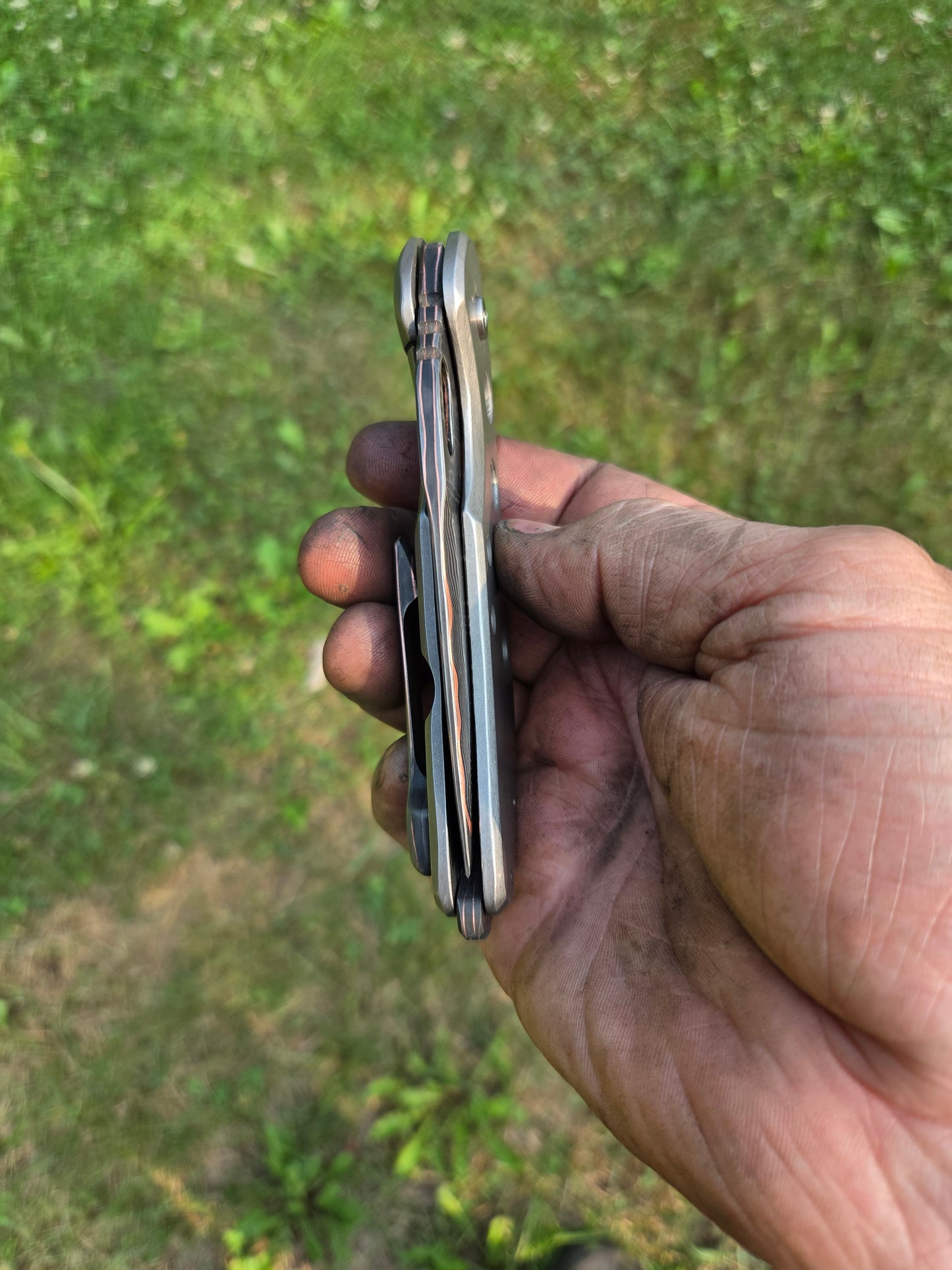 Copper Damascus titanium frame lock.