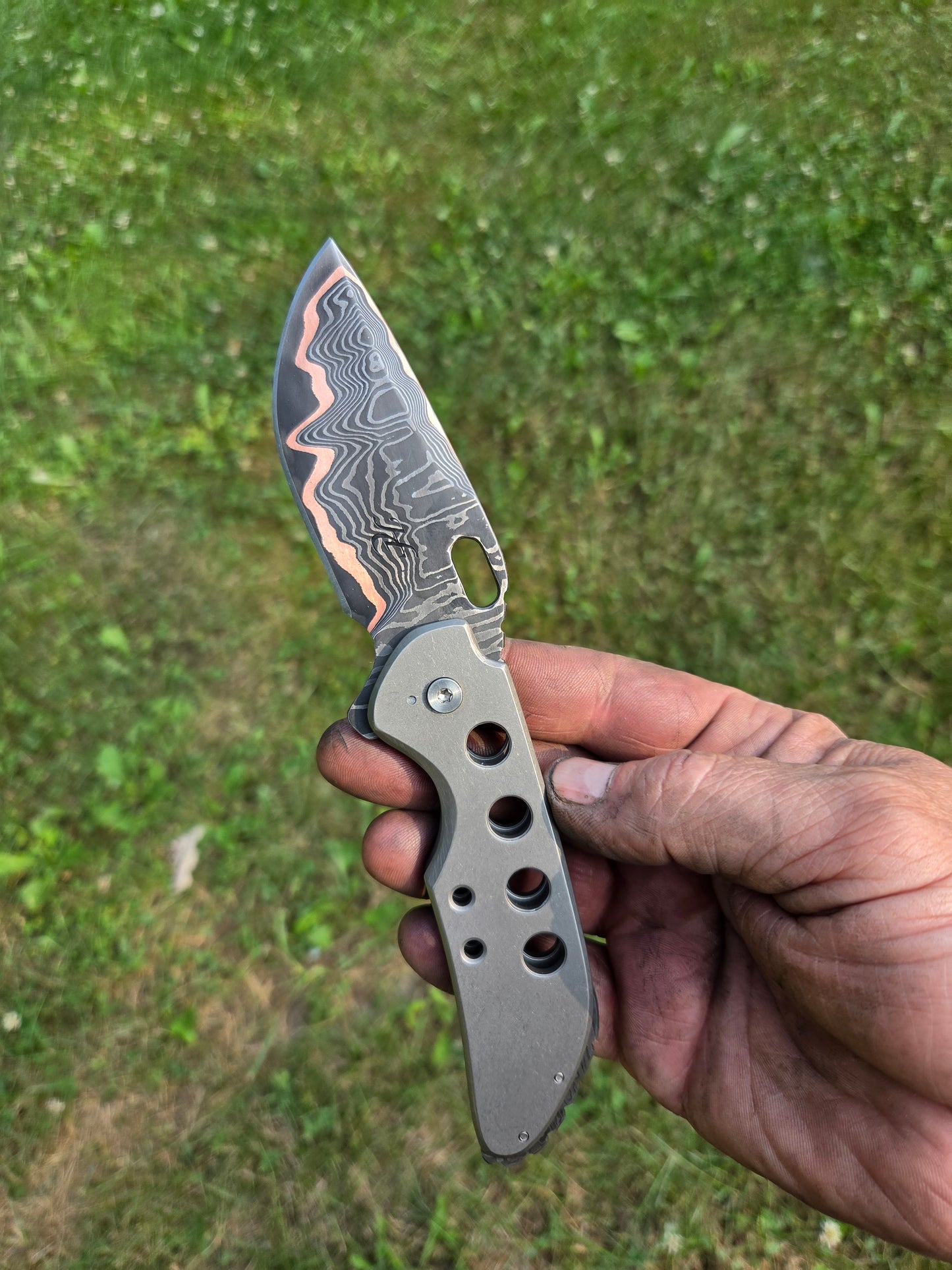 Copper Damascus titanium frame lock.