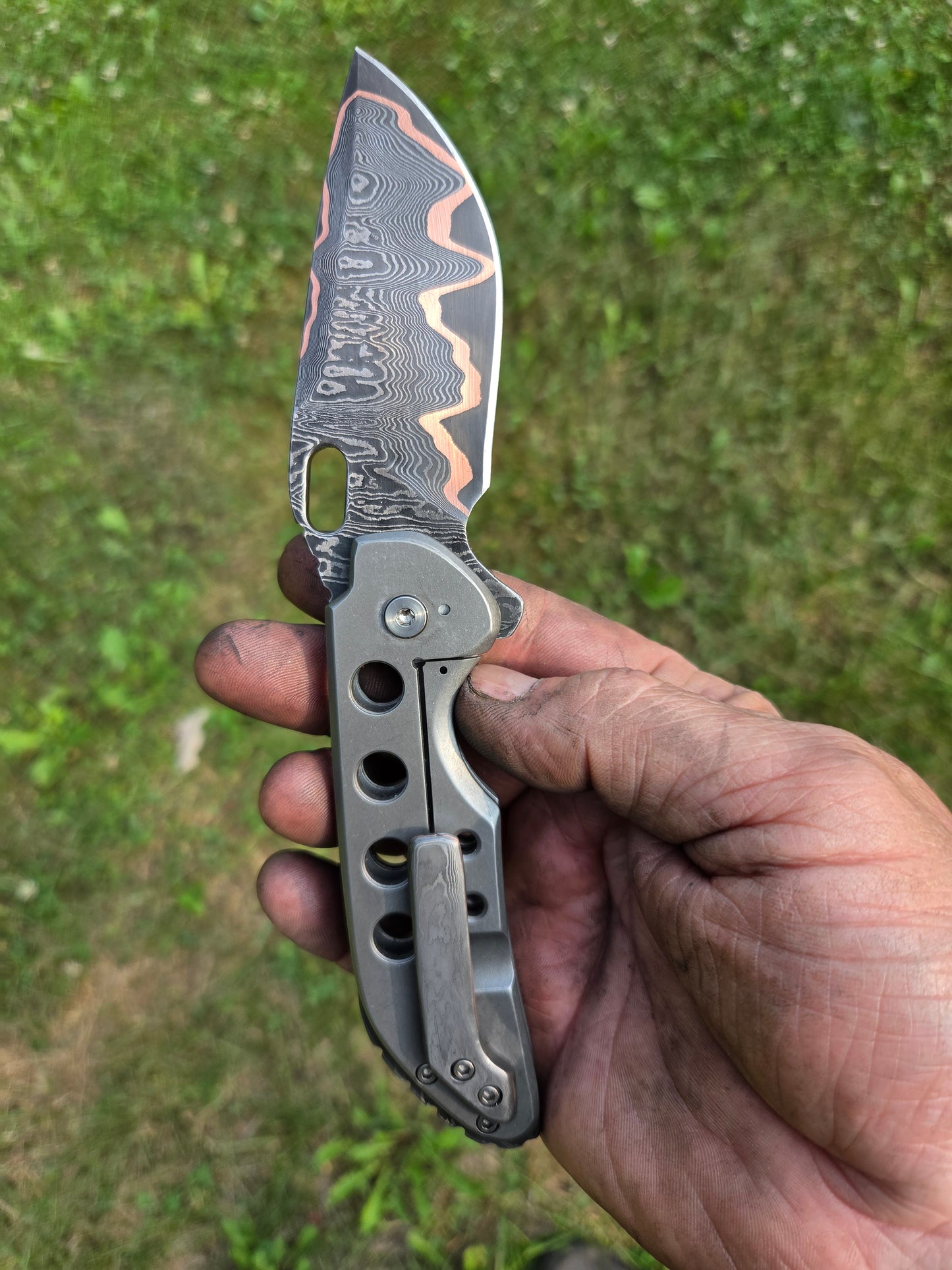 Copper Damascus titanium frame lock.
