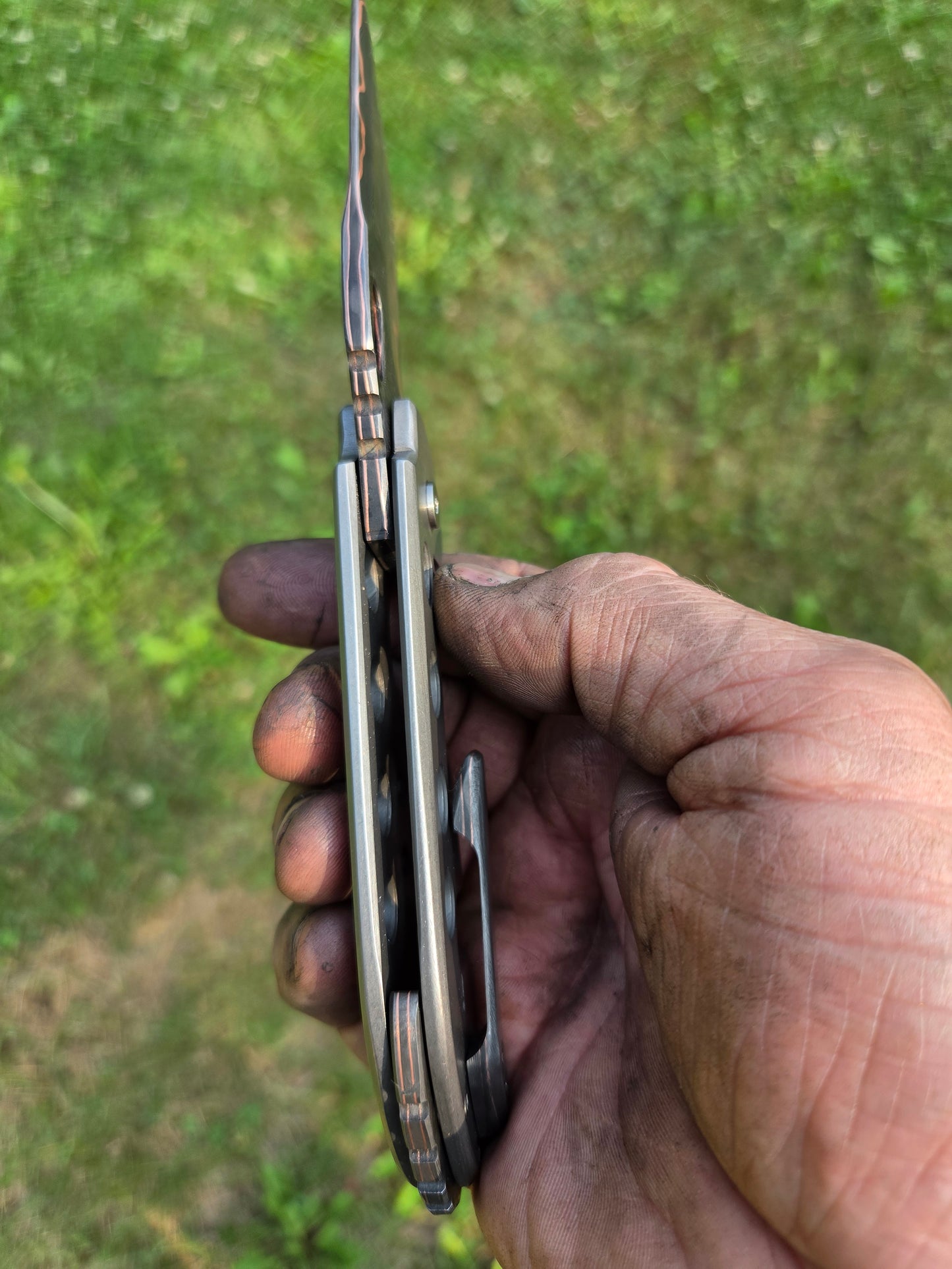 Copper Damascus titanium frame lock.