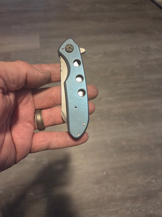 Blue anodized titanium frame lock