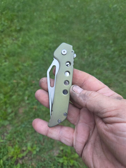 Green titanium frame lock
